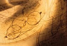 A close up of a map with glasses on it